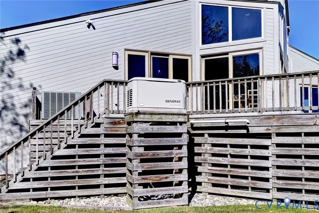 a view of balcony with wooden floor and potted plants