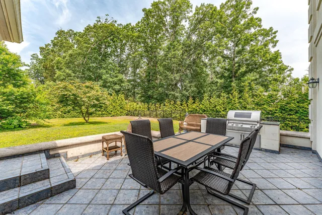 a roof deck with a table and chairs and couches