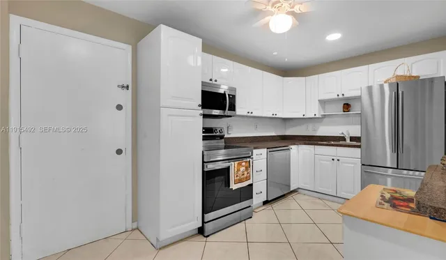a kitchen with stainless steel appliances granite countertop a stove a microwave and a sink
