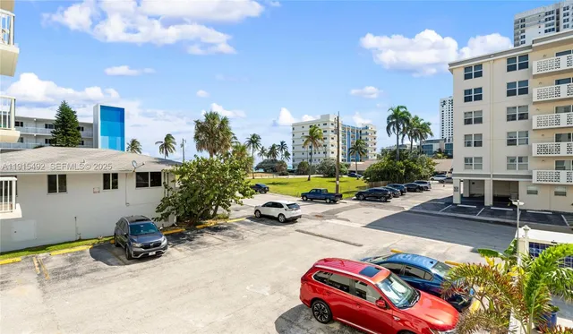 a view of a patio with couches and chairs with wooden floor