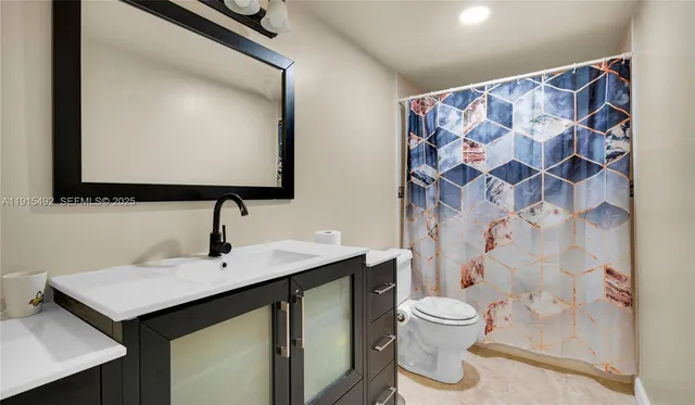 a kitchen with a sink appliances and cabinets