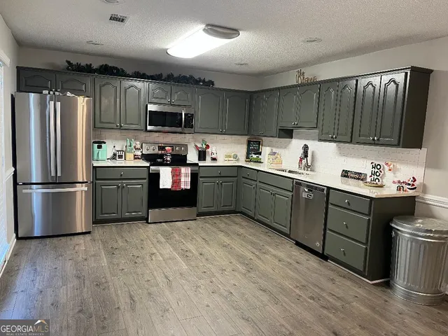 a kitchen with lots of counter top space and stainless steel appliances