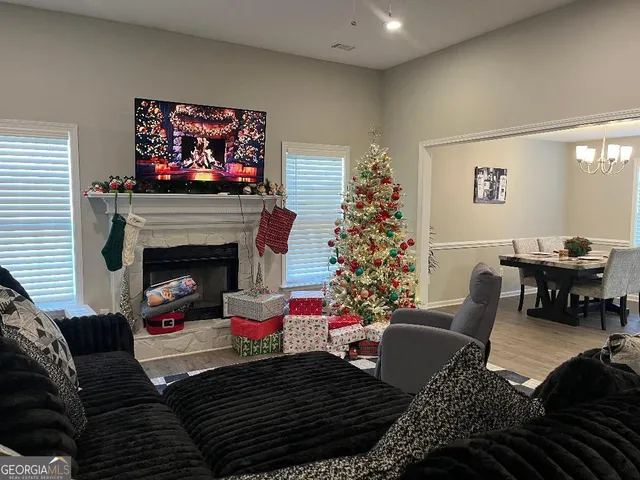 a living room with furniture fireplace and a large window