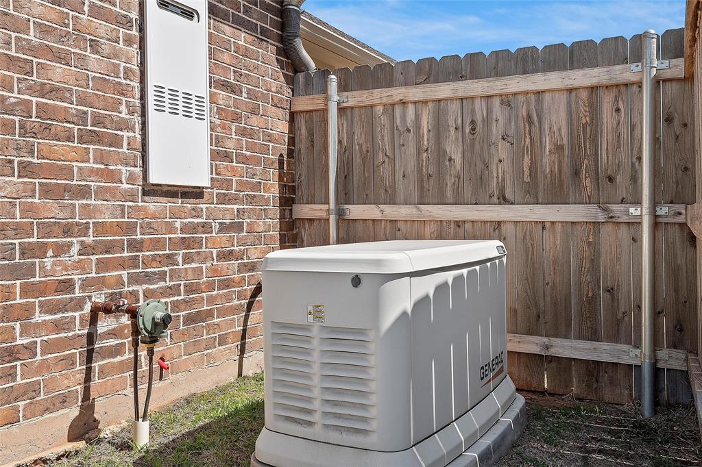 23 Independence Trail Waco, TX 76708 - Photo 32 of 35 Whole-home generator system and tankless water heater, set against a brick exterior and wood fence