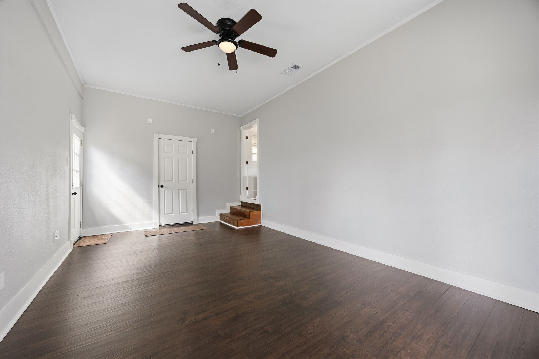 1402 Kent Street Taylor, TX 76574 - Photo 12 of 25 an empty room with wooden floor and windows