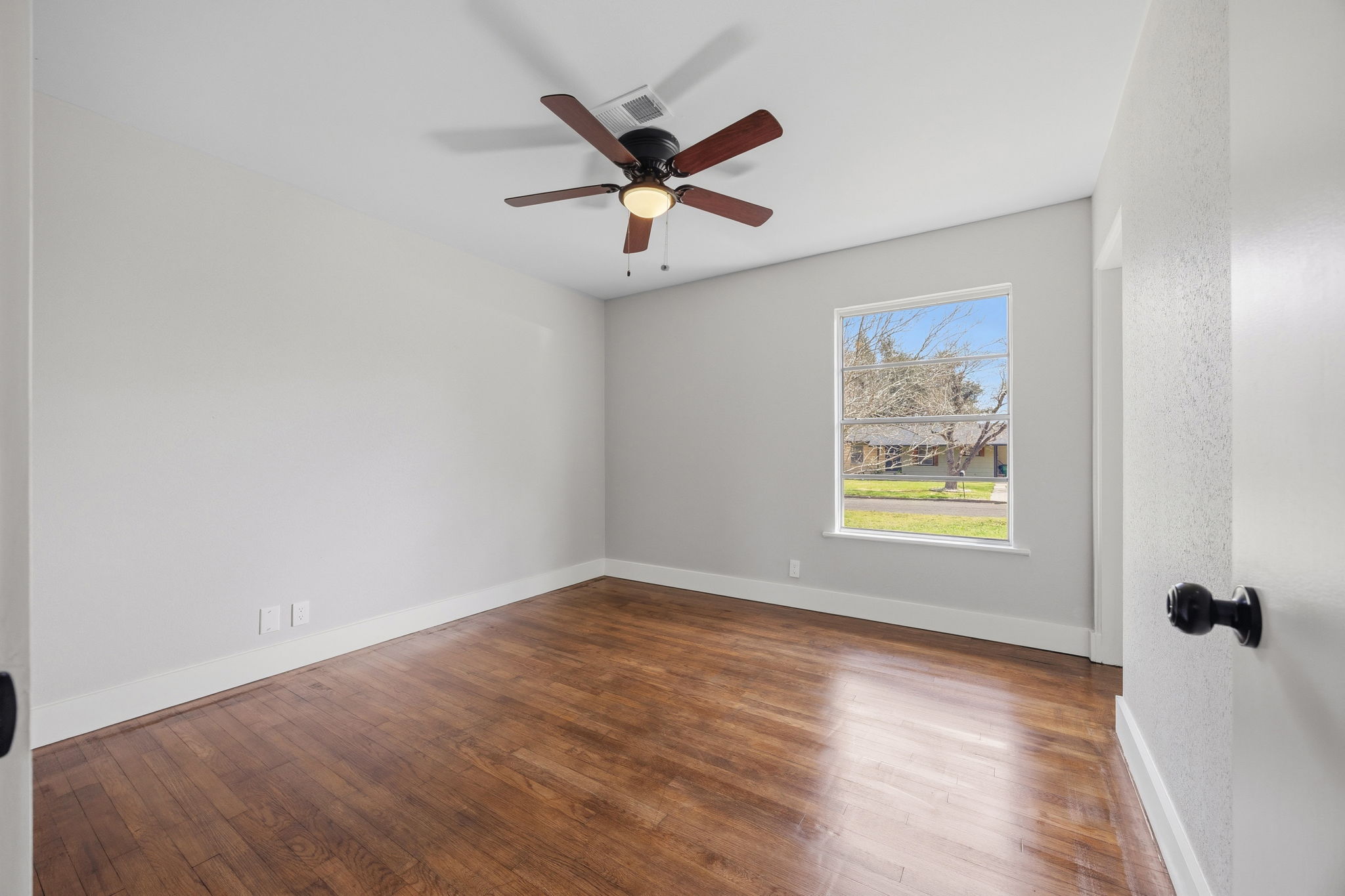 1402 Kent Street Taylor, TX 76574 - Photo 13 of 25 a view of a ceiling fan and wooden floor