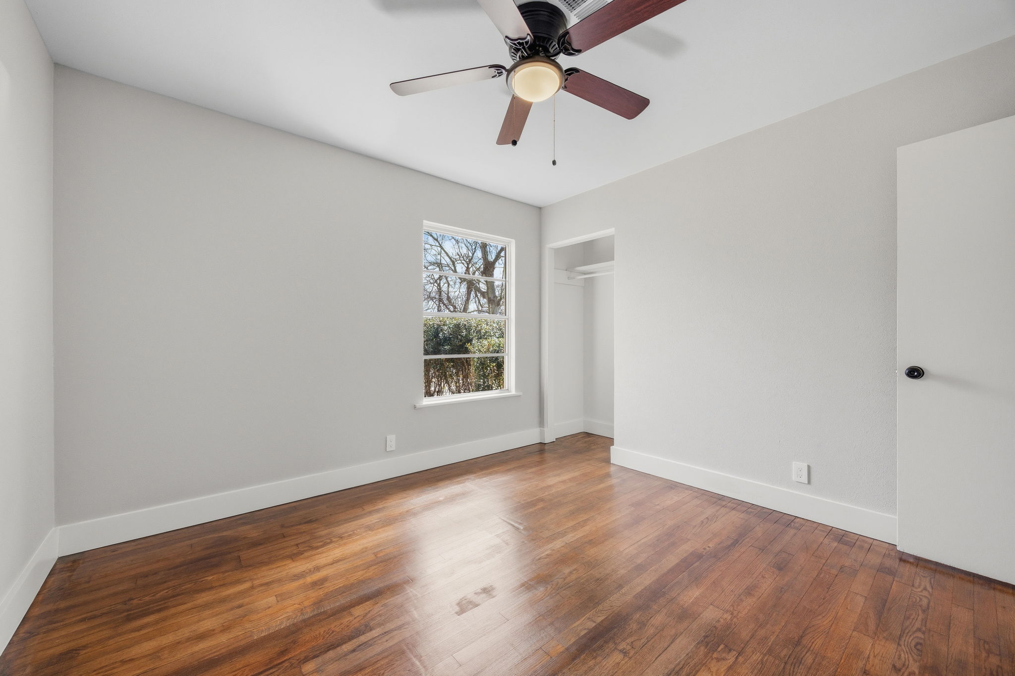1402 Kent Street Taylor, TX 76574 - Photo 14 of 25 wooden floor in an empty room with a window