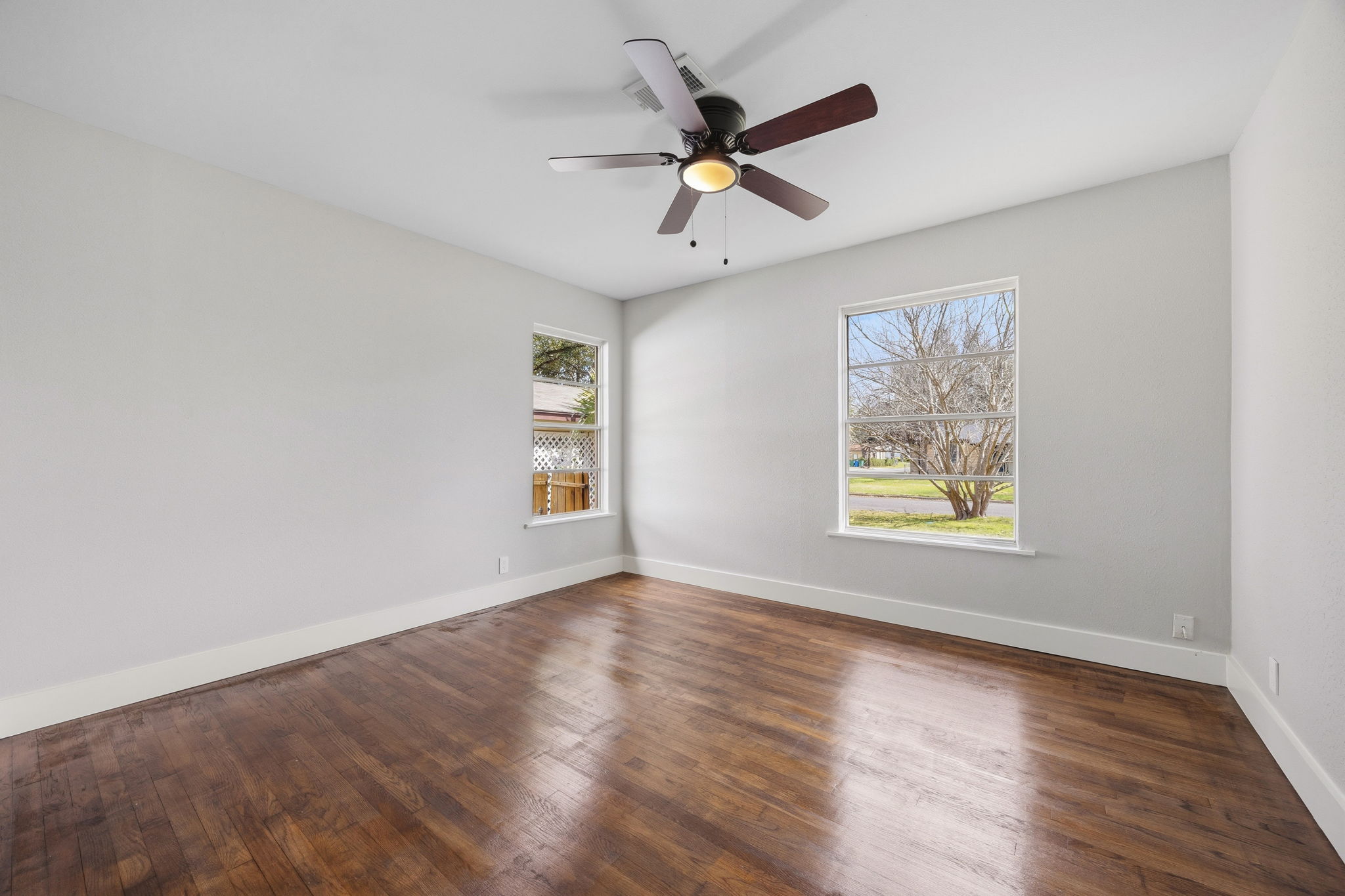 1402 Kent Street Taylor, TX 76574 - Photo 20 of 25 a view of empty room with wooden floor and fan