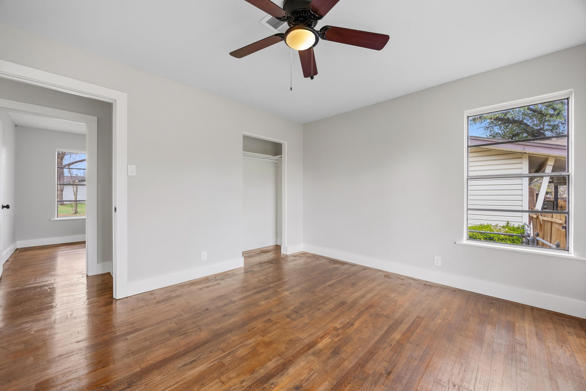 1402 Kent Street Taylor, TX 76574 - Photo 21 of 25 a view of an empty room with window and wooden floor