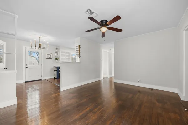 a view of empty room with wooden floor