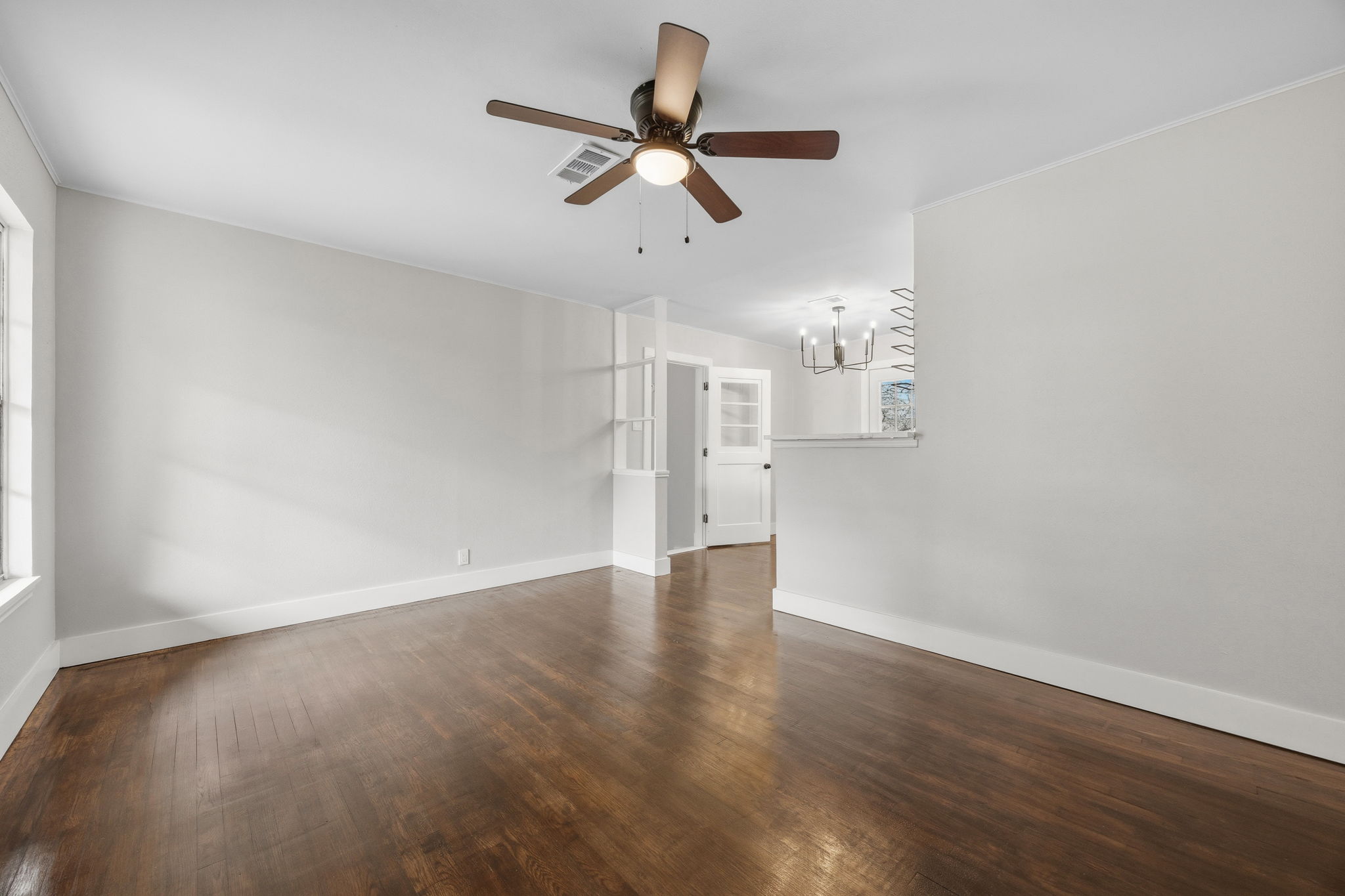 1402 Kent Street Taylor, TX 76574 - Photo 5 of 25 a view of empty room with wooden floor and ceiling fan
