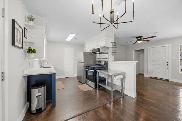 a kitchen with cabinets and wooden floor
