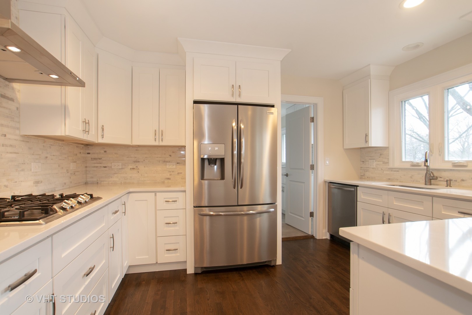 2010 Clover Road Northbrook, IL 60062 - Photo 12 of 30 a kitchen with wooden floors white cabinets and stainless steel appliances