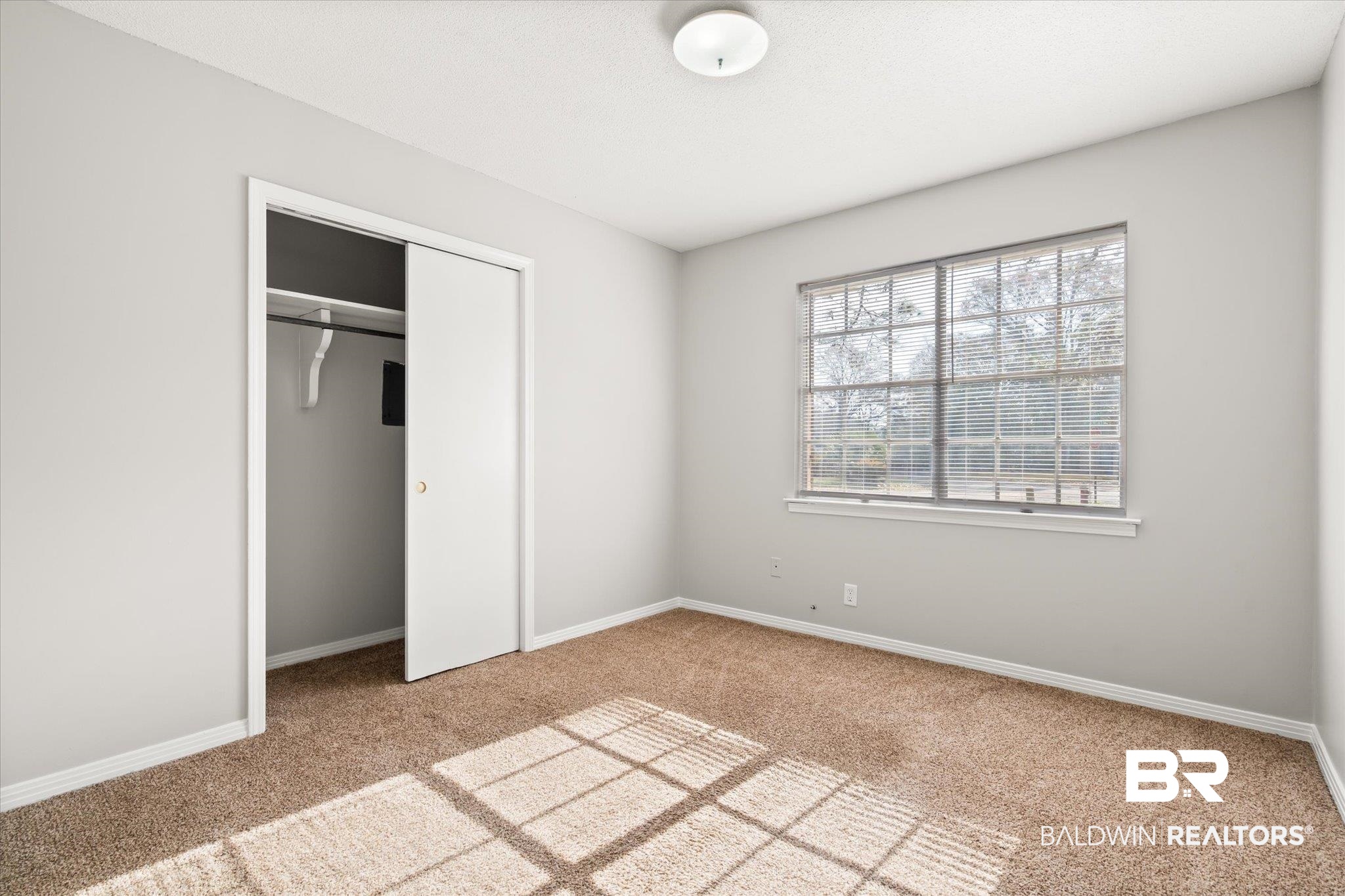 6848 Sandra Drive Theodore, AL 36582 - Photo 8 of 21 Unfurnished bedroom with carpet floors and a closet