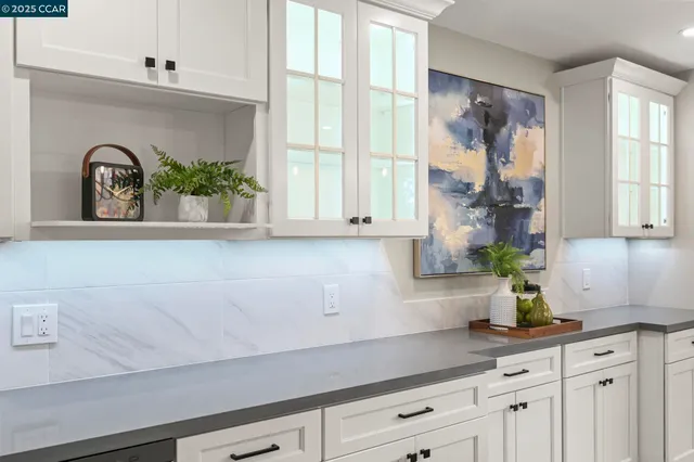 a bathroom with a potted plant on the counter and sink
