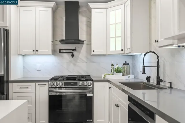 a kitchen with stainless steel appliances granite countertop a sink stove and cabinets