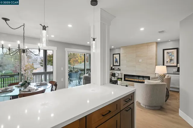 a large kitchen with kitchen island a sink appliances and a large window