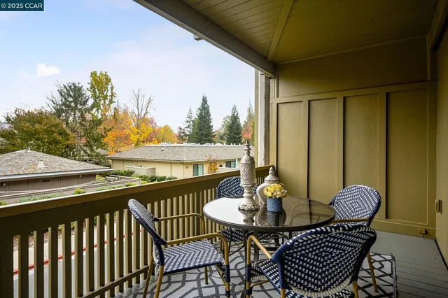 a view of a balcony with table and chairs