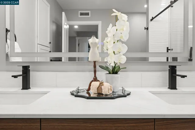 a bathroom with a granite countertop sink a shower and a mirror