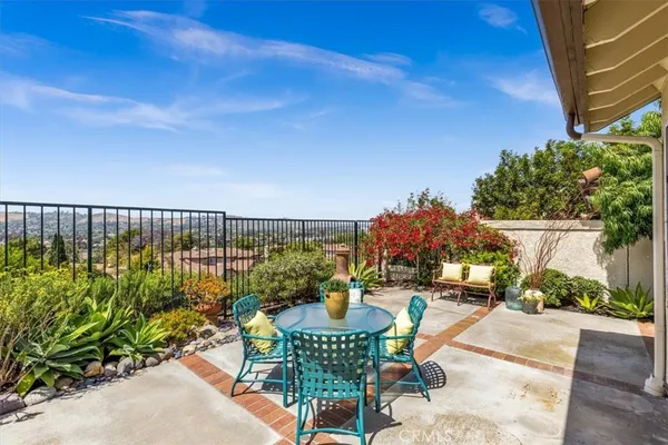 a balcony with table and chairs
