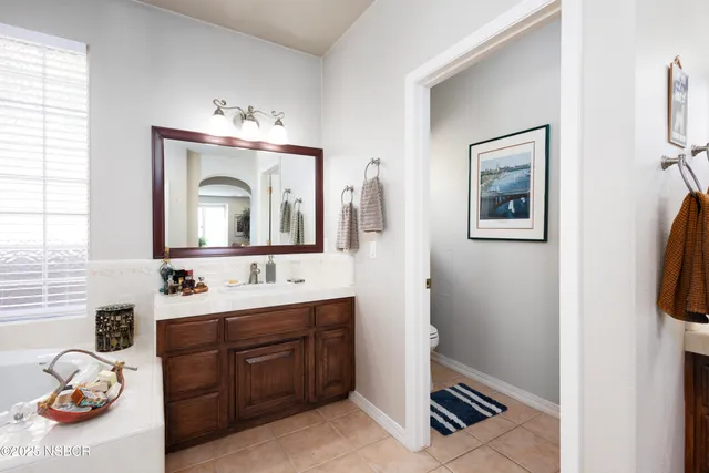 a bathroom with a sink a vanity and a mirror