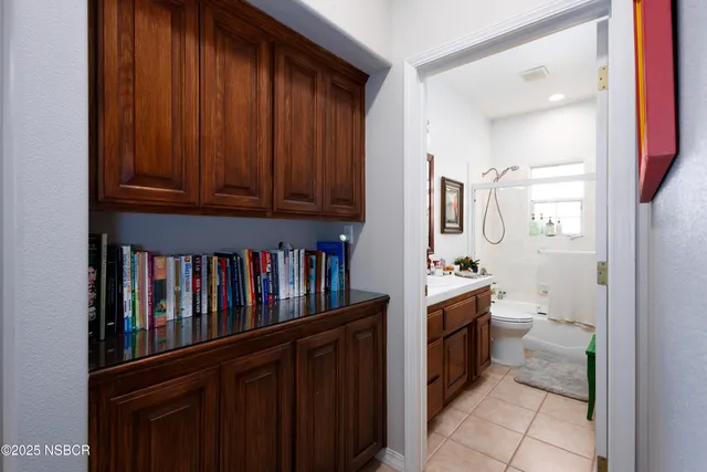 a room with a cabinets and toilet