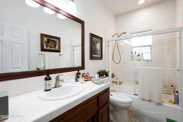 a bathroom with a sink toilet and a mirror