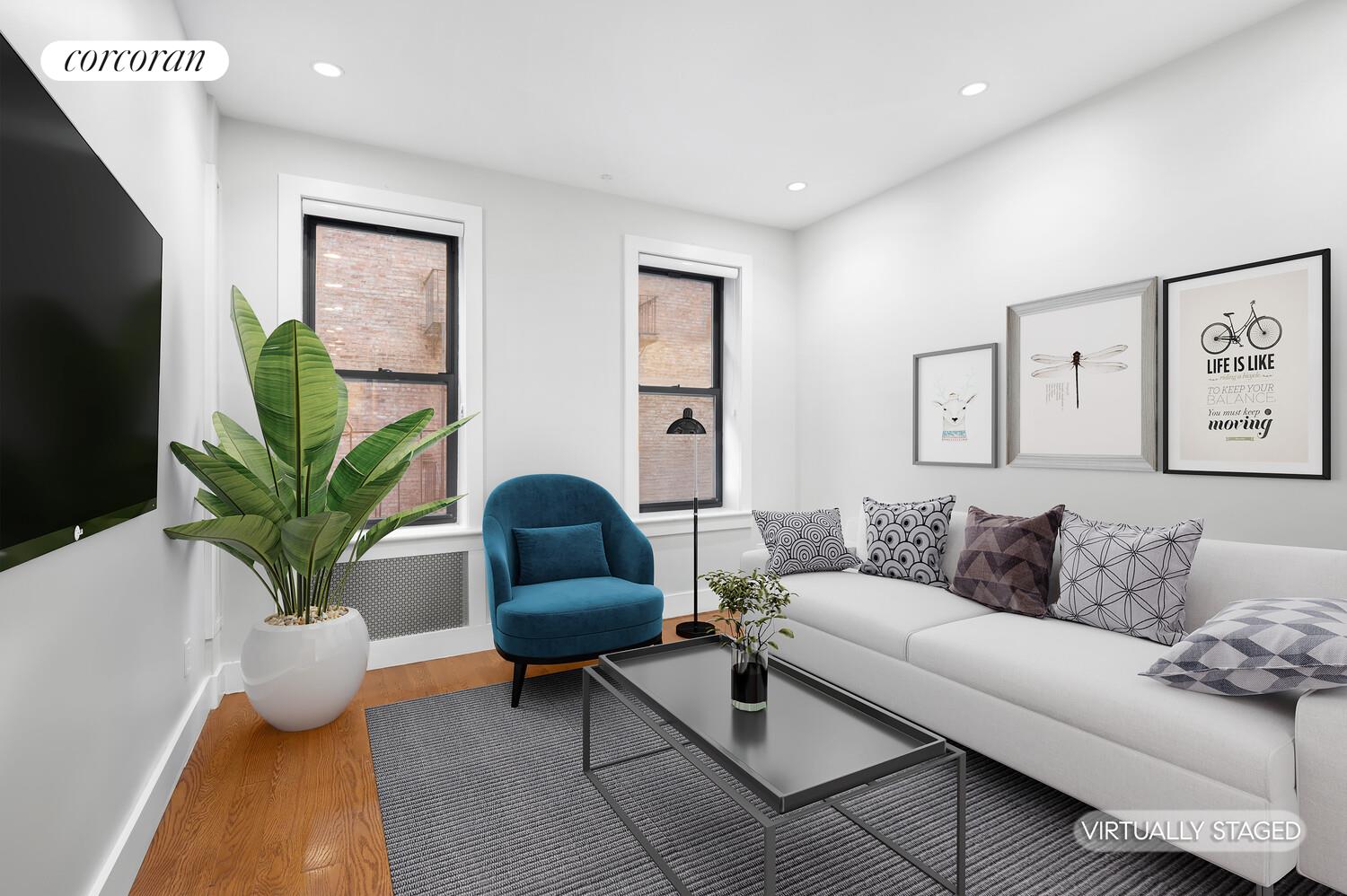 a living room with furniture and a potted plant