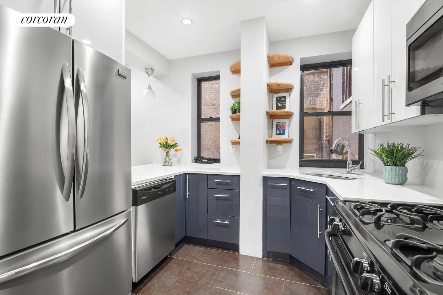 825 West 179th Street, Unit 2E Manhattan, NY 10033 - Photo 2 of 9 a kitchen with stainless steel appliances granite countertop a refrigerator and a stove