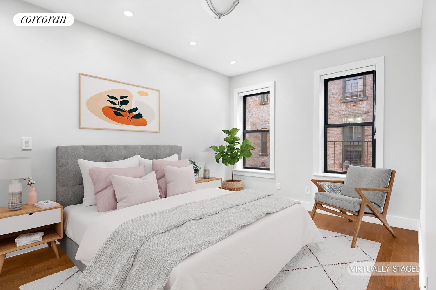 825 West 179th Street, Unit 2E Manhattan, NY 10033 - Photo 3 of 9 a bedroom with a bed and glass windows