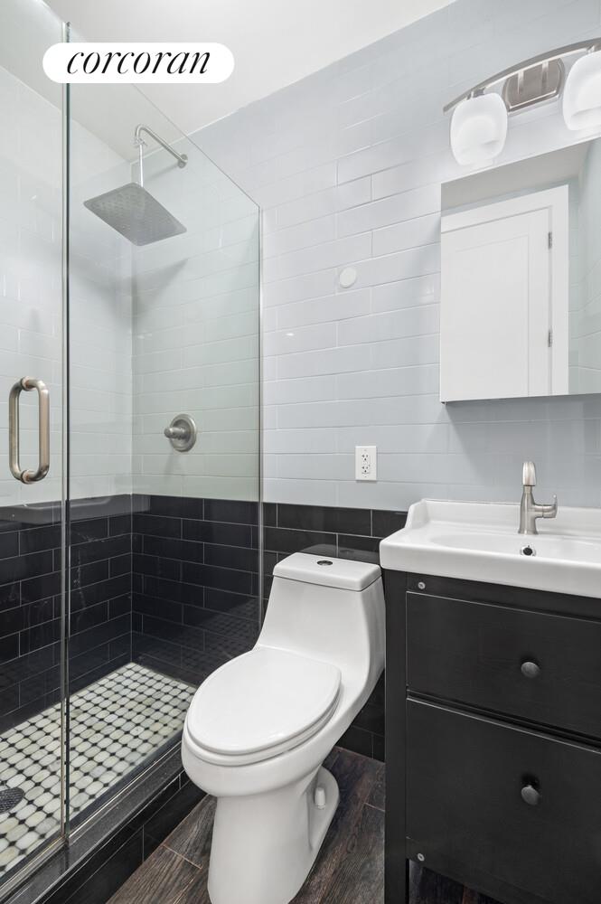 825 West 179th Street, Unit 2E Manhattan, NY 10033 - Photo 4 of 9 a bathroom with a sink toilet and shower