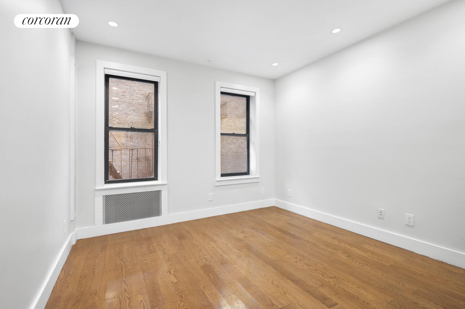 825 West 179th Street, Unit 2E Manhattan, NY 10033 - Photo 6 of 9 a view of empty room with wooden floor and fan