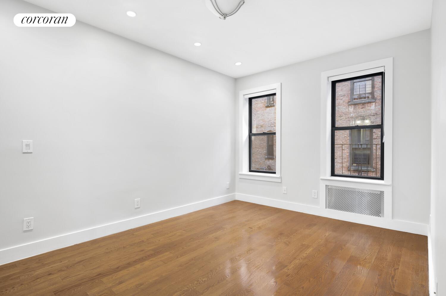 825 West 179th Street, Unit 2E Manhattan, NY 10033 - Photo 7 of 9 an empty room with windows