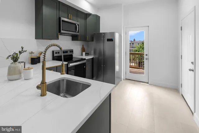 a kitchen with a refrigerator sink and microwave