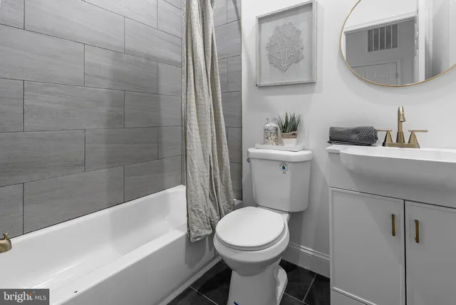 a bathroom with a toilet a sink and bathtub