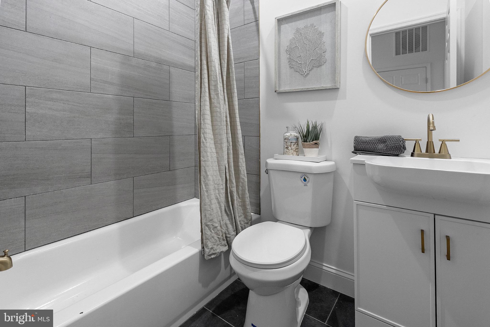 2106 McCulloh Street Baltimore, MD 21217 - Photo 12 of 38 a bathroom with a toilet a sink and bathtub