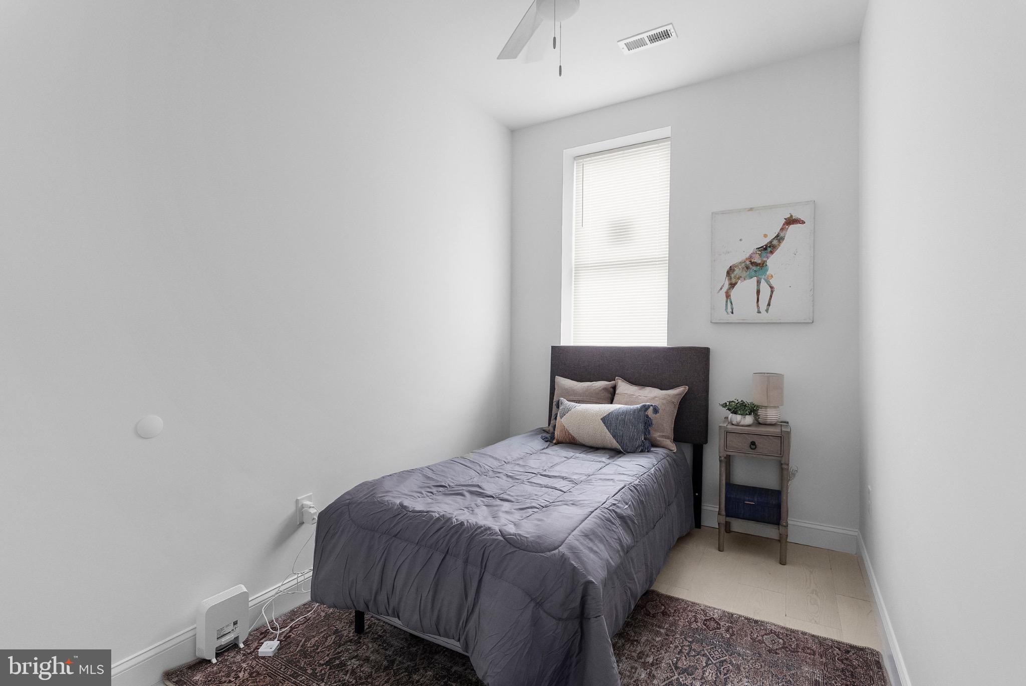 2106 McCulloh Street Baltimore, MD 21217 - Photo 15 of 38 a bedroom with a bed and a window