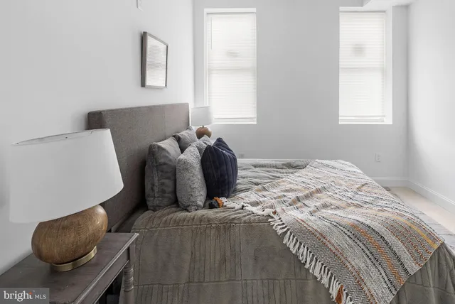 a bedroom with a bed and window