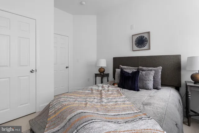 a bed sitting in a bedroom and a lamp