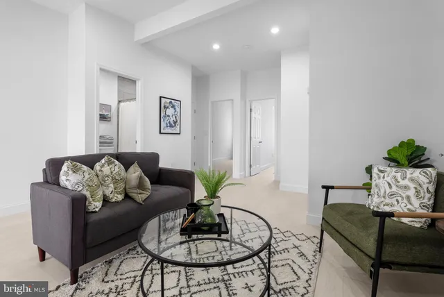 a living room with furniture and a dining table