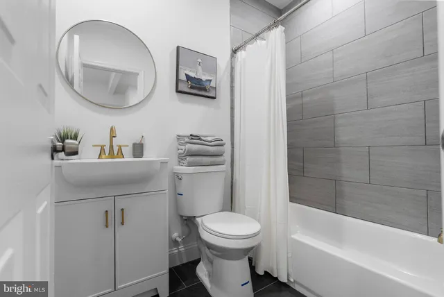 a bathroom with a toilet a sink and bathtub