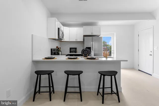 a kitchen with stainless steel appliances a sink and cabinets