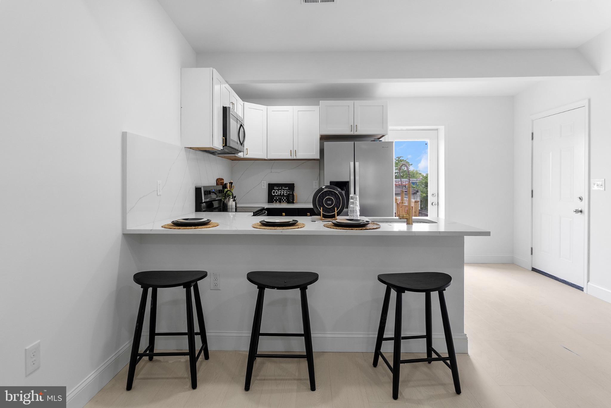 2106 McCulloh Street Baltimore, MD 21217 - Photo 23 of 38 a kitchen with stainless steel appliances a sink and cabinets