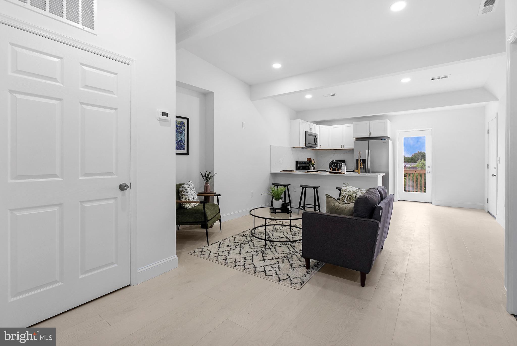 2106 McCulloh Street Baltimore, MD 21217 - Photo 24 of 38 a living room with furniture and a wooden floor