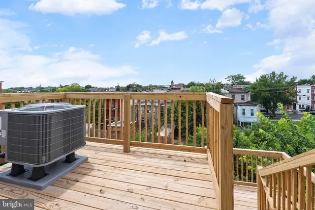 a view of roof deck with two couches and wooden floor