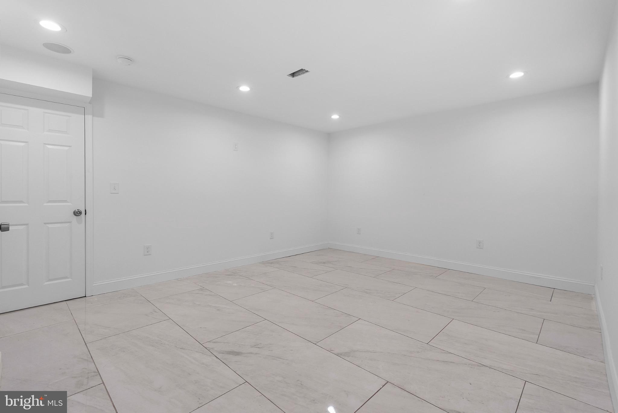 2106 McCulloh Street Baltimore, MD 21217 - Photo 32 of 38 an empty room with white walls and tiles