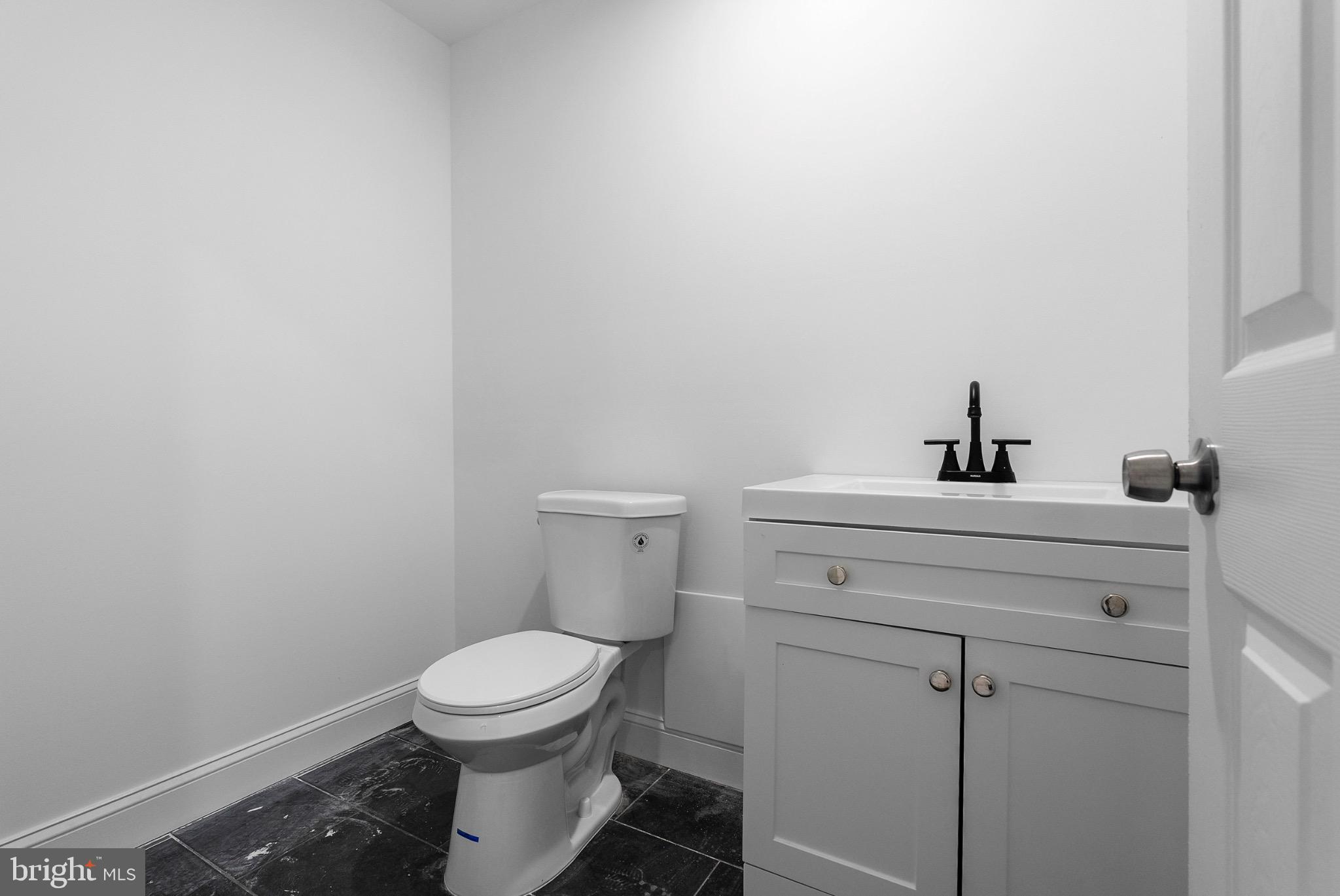 2106 McCulloh Street Baltimore, MD 21217 - Photo 33 of 38 a bathroom with a toilet a sink and mirror