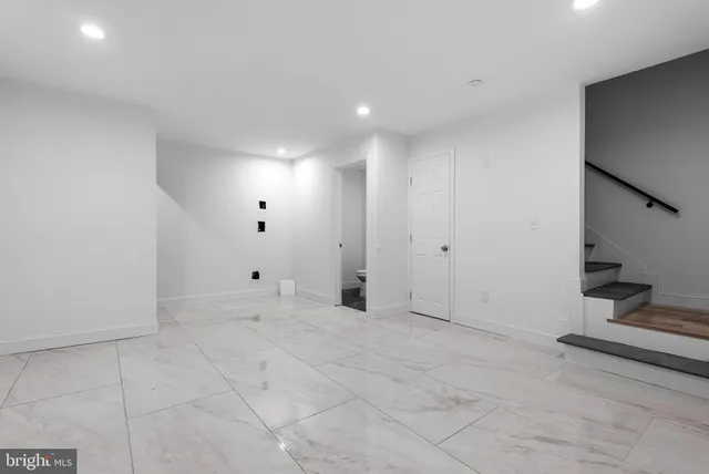 a view of an empty room with stairs