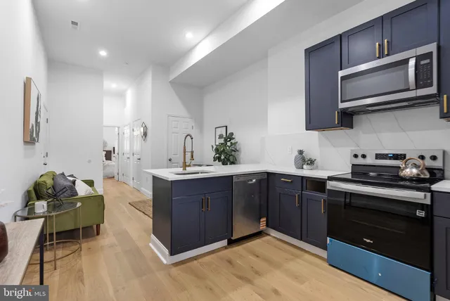 a kitchen with stainless steel appliances granite countertop wooden cabinets stove top oven and sink