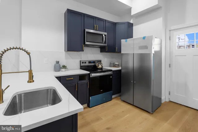 a kitchen with a refrigerator sink and microwave